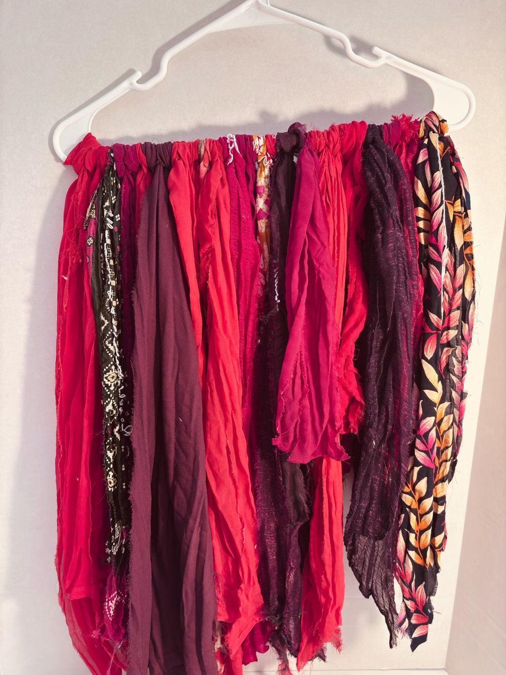 Vibrant sari silk fabric strip Collection in red and burgundy hues.